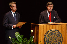 L. Paul Bremer III behind a lecturn next to Bob Bottoms