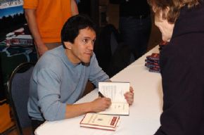 Mitch Albom talking with a visitor during the book signing