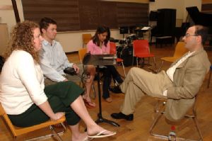 Charles Fishman speaking with students