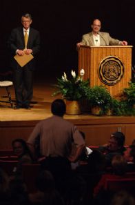 Charles Fishman and Bob Bottoms on stage following a student question