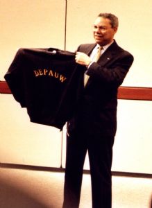 Colin Powell holding up a DePauw sweatshirt