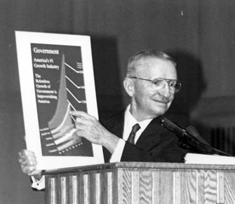 Ross Perot holding a government chart