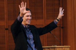 Jim Alling with outstretched arms during the Ubben Lecture