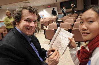 Greg Mortenson with a student at the book signing