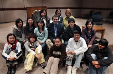 Greg Mortenson sitting with students