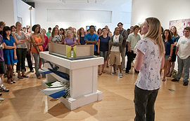 Faculty member providing a gallery talk along with a piece of art