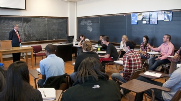 Oscar Arias in a classroom talking with students