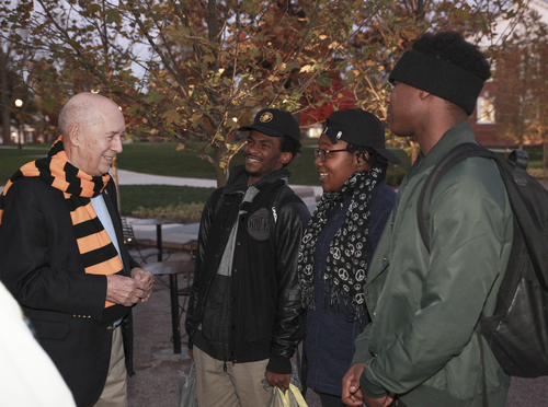 Bill Rasmussen talking with students outside
