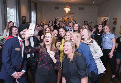 Jenna Fischer taking a selfie with students