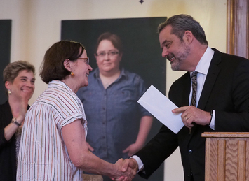 Marion K. McInnes accepting award from Mark McCoy