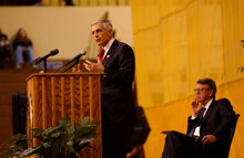 General Wesley K. Clark behind a lecturn during an Ubben Lecturn with Bob Bottoms looking on