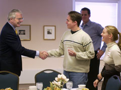 John Major shaking hands with a student