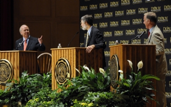 Karl Rove debating a point with Howard Dean and Bruce Stinebrickner looking on