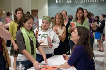 Rebecca signing books for students