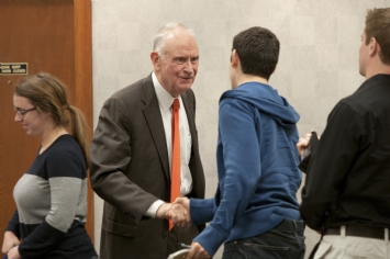 Lee Hamilton shaking hands with a lecture attendee